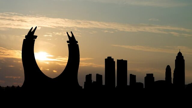 The crescent tower in the newly developing city Lusail in Qatar. Time Lapse at Sunrise with Colorful Clouds