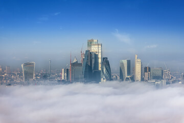 The modern skyline of the City of London peaking out of the fog on a cold winter day, England