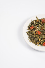 Green tea with aromatic additives. Top view on white background