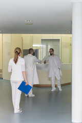 three doctors in a hospital corridor