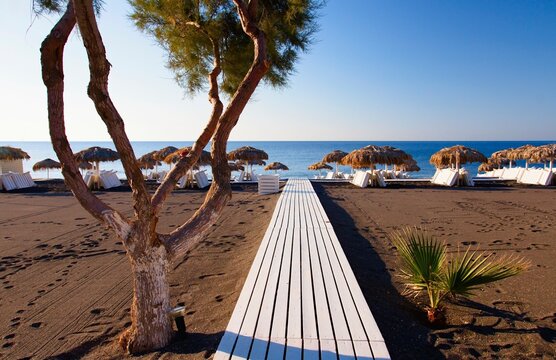 Black beach in the resort of Perissa on the island of Santorini in the Aegean Sea in the South Cyclades archipelago of Greece.