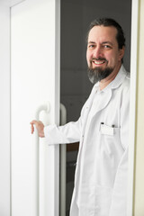 Fototapeta premium portrait of a smiling doctor standing at the door