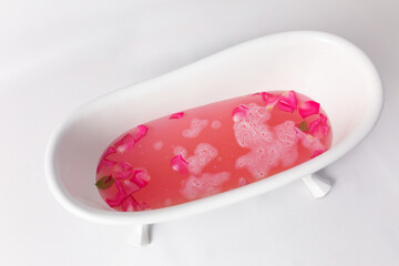 Rose petals put in bathtub for romantic bathroom in honeymoon suit.Arranged by interior designer for honeymoon couple. Scent of rose make relax. Spa shop put flowers in the tub with towels for lover.
