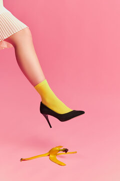 Naklejki Creative colorful portrait of female leg in bright yellow socks and banana peel over pink background. Vintage style. Concept of retro fashion, art photography, beauty