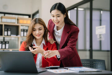 Asian women brainstorming and discussing with financial data and report graph at home office.
