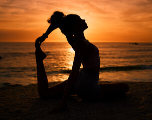 Pilates, yoga and silhouette of woman on beach at sunrise for exercise, training and fitness...