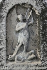 Fototapeta na wymiar a worn and weathered stone carving of St Michael the Archangel