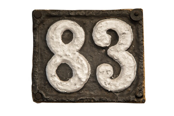 Old retro weathered cast iron plate with number 83 closeup isolated on white background