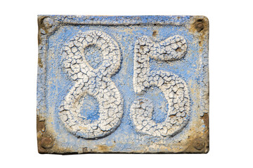 Old retro weathered cast iron plate with number 85 closeup isolated on white background