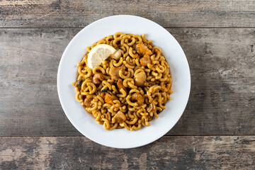Traditional Spanish fideua. Noodle paella on wooden table