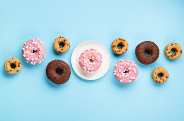 Donuts Doughnuts with Chocolate, Pink Marshmallow and Sugar Sprinkles on Blue Background