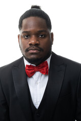 Cool young positive african american man in classic elegant black suit on white background. Portrait of showman or presenter of festive event who smiles at camera.