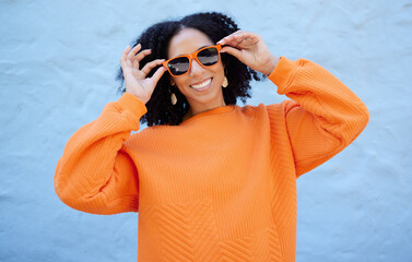Fashion portrait, sunglasses and black woman isolated on blue background gen z, youth or trendy...