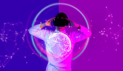 Metaverse technology concept. Man in white t shirt wearing vr headset watching and connecting to world virtual data and entertainment on purple and violet background.