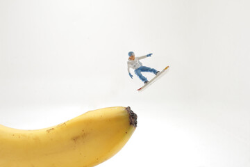 the mini figure of Snowboarder jumping on banana
