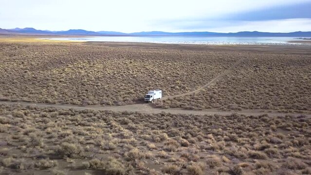 Drone zooming out showing a desert, mountains and mono lake.