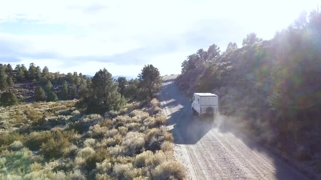 Car dustclouds, gravel road, sierra desert.