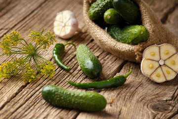 Fresh cucumbers in a bag on a wooden surface. Organic vegetables. Harvest of cucumbers.