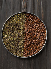 Green tea and coffee grains on a dark wooden background top view.