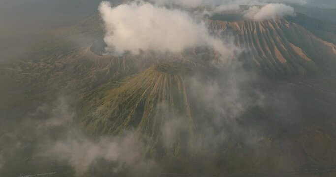 Aerial Panning Shot Of Smoke Emitting From Mount Bromo During Sunset - Java, Indonesia