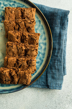 Overhead view of a row of chocolate cookies on a plate