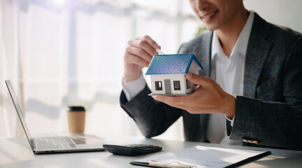 Considering buying a home, investing in real estate. Broker signs a sales agreement. agent, lease agreement, successful deal