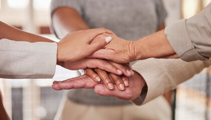 People, hands and unity in trust for community, agreement or teamwork at the office. Group piling hand for team collaboration, support or coordination for corporate goals in solidarity at workplace