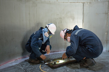 Male worker inspection vacuum test weld tank stainless steel