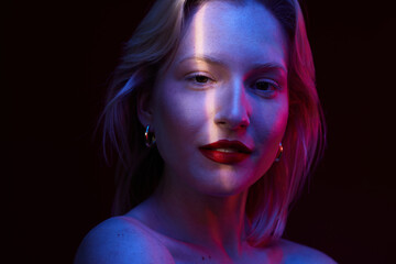 Portrait of a young blond woman isolated on magenta background. Viva magenta.