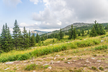 Forests and mountains of the Southern Urals near the village of Tyulyuk in Russia. Drone view.