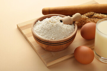 Ingredients for baking or cooking, egg flour, rolling pin butter, milk on a beige background Cookie pie or cake recipe.