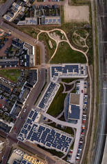 Panorama top down of Ubuntuplein residential community complex seen from above with roof full of solar panels with Ettegerpark next to train tracks. Aerial housing and engineering concept