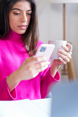 woman using smartphone at home