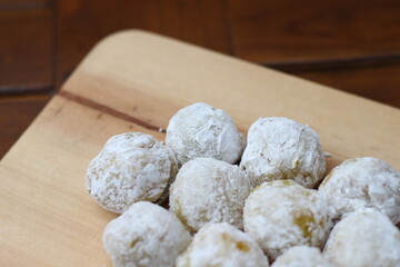 a close up of durian-flavored Japanese rice cake made of mochigome served on a cutting board and ready to be eaten.