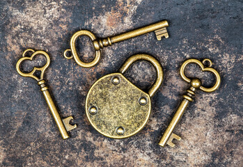 Old vintage keys and padlock on a rusty grunge metal background. Escape room game.