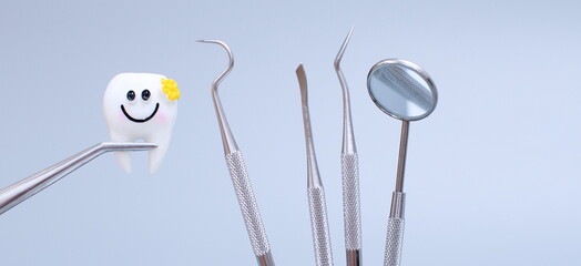 Dental tools and model of teeth on a blue background. Dental care concept. Invisible braces