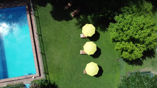 Cabin with pool and umbrellas and vegetation flight drone 4k <> Argentina buenos aires Escobar
