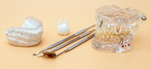 Orthodontic dental theme on yellow background.Transparent invisible dental aligners or braces aplicable for an orthodontic dental treatment