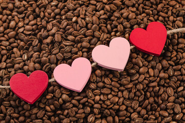 red and pink hearts on coffee beans, concept of san valentin en colombia