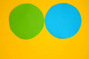 Two circles - green and blue on a yellow background. A space to create ideas.