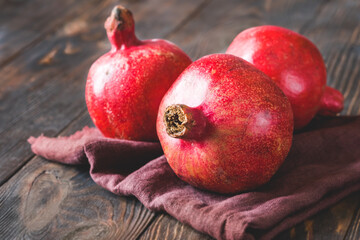 Fresh pomegranates on the wooden table