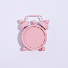 Pastel pink, retro style alarm clock without numbers, minimal creative time concept, white background. 