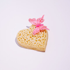 Heart shape crumpet with spring inspired decorative element, creative love and passion layout, white background. 