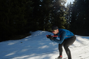 Nordic skiing or Cross-country skiing classic technique practiced by man in a beautiful panoramic...