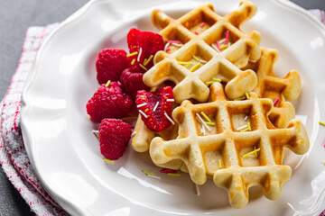 waffles with raspberries Belgian or American dessert fast food healthy meal food snack on the table copy space food background rustic top view