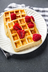 waffles with raspberries Belgian or American dessert fast food healthy meal food snack on the table copy space food background rustic top view