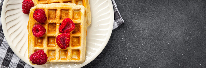 waffles with raspberries Belgian or American dessert fast food healthy meal food snack on the table...