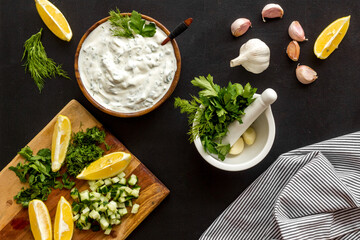 Greek dip sauce ingredients - sour cream with herbs cucumber