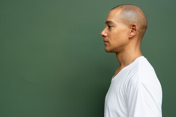 Profile view portrait of handsome bald man wearing t-shirt - 569903390