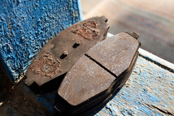 Photo of used brake pads on the wood